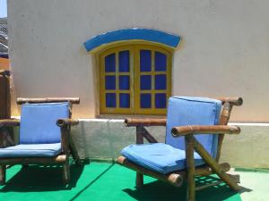 two chairs sitting in front of a house at Neptune Hotel in Dahab