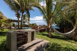 ein Resort mit einer Hängematte, Palmen und dem Meer in der Unterkunft Coco Ne in Máncora