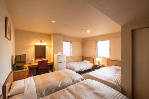 Postel nebo postele na pokoji v ubytování Oka Hotel