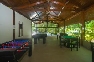 una habitación con varias mesas y mesas de ping pong en Flat com serviços na Riviera, en Bertioga