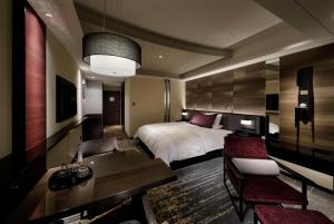 a hotel room with a bed and a table and chairs at Hotel Granvia Kyoto in Kyoto