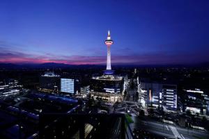 a view of a city at night with a tower at Hotel Granvia Kyoto in Kyoto