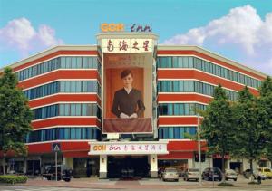 a building with a large poster of a man on it at Shenzhen Green Oasis Hotel, Baoan in Bao'an