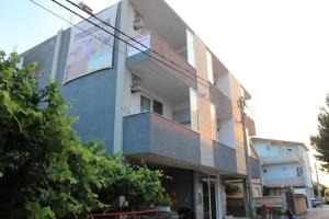 a building with a staircase on the side of it at Presheva Rooms in Ulcinj