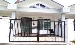 a black gate in front of a house at Ahnaf Homestay Bandar Penawar Desaru in Desaru