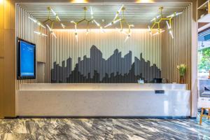 a lobby with a wall mural of a city at Atour Hotel Hangzhou West Lake in Hangzhou