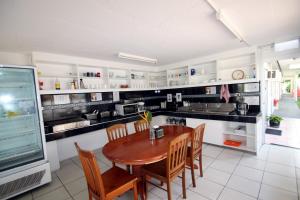 a kitchen with a wooden table and chairs at CStay in Picnic Bay