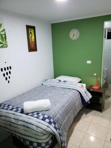 a bedroom with a bed with two towels on it at SALITRE SPA in Pozo Almonte