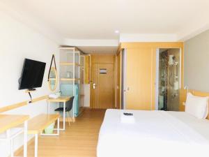 Postel nebo postele na pokoji v ubytování Ingnaam Hotel