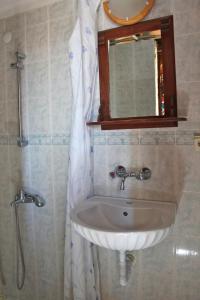 a bathroom with a sink and a mirror and a shower at Homeros Pension & Guesthouse in Selcuk +47 photos