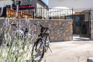 een fiets geparkeerd naast een stenen muur bij Relax Village Home Mare in Krk