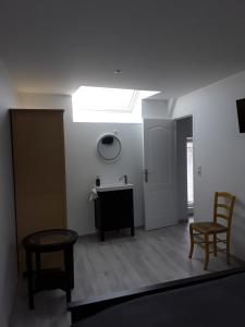 ein Wohnzimmer mit einem Dachfenster sowie einem Tisch und Stühlen in der Unterkunft Le Gîte Dameryat in Damery