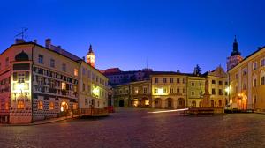 a group of buildings with a clock tower in the background at Apartmánek Patricie room with kitchenette suitable for 2 adults and 2 children in Mikulov
