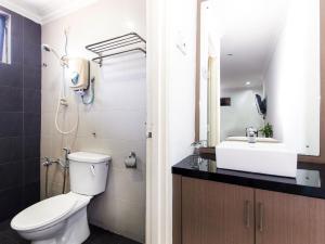 a bathroom with a toilet and a sink at Crystal City Hotel in Kuantan