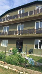 a building with a fence in front of it at Green House in Grigoleti +13 photos