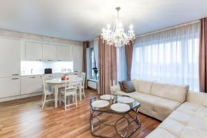a living room with a couch and a table at Pallasti Luxury Apartment in Tallinn