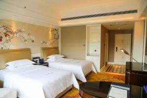 Ένα ή περισσότερα κρεβάτια σε δωμάτιο στο Shenzhen Dayhello international Hotel (Baoan)