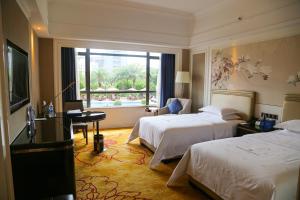 Ένα ή περισσότερα κρεβάτια σε δωμάτιο στο Shenzhen Dayhello international Hotel (Baoan)