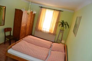 1 dormitorio con 2 camas y ventana en Weinbauernhof Löscher, en Retz