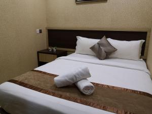 Postel nebo postele na pokoji v ubytování Hotel Grand Palace Ampang