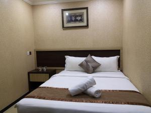 Postel nebo postele na pokoji v ubytování Hotel Grand Palace Ampang