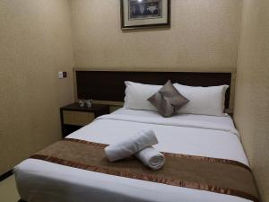 Postel nebo postele na pokoji v ubytování Hotel Grand Palace Ampang