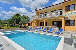 a villa with a swimming pool and a house at House Smiljana 2059 in Vodnjan