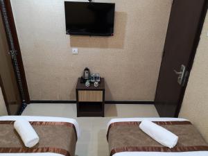 Postel nebo postele na pokoji v ubytování Hotel Grand Palace Ampang