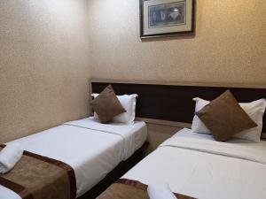 Postel nebo postele na pokoji v ubytování Hotel Grand Palace Ampang
