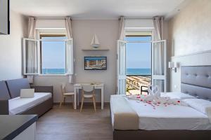 a hotel room with a bed and a table and chairs at Hotel Biagi & Residence in Lido di Camaiore