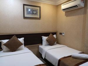 Postel nebo postele na pokoji v ubytování Hotel Grand Palace Ampang
