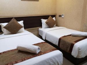 Postel nebo postele na pokoji v ubytování Hotel Grand Palace Ampang