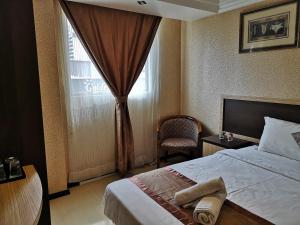 Postel nebo postele na pokoji v ubytování Hotel Grand Palace Ampang