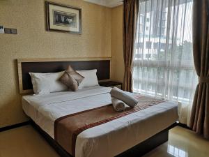 Postel nebo postele na pokoji v ubytování Hotel Grand Palace Ampang