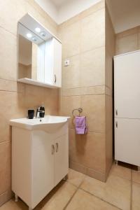 a bathroom with a white sink and a mirror at Apartments Galboka in Nerezine +151 photos