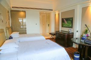 Ένα ή περισσότερα κρεβάτια σε δωμάτιο στο Shenzhen Dayhello international Hotel (Baoan)