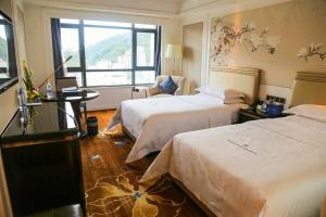 Ένα ή περισσότερα κρεβάτια σε δωμάτιο στο Shenzhen Dayhello international Hotel (Baoan)