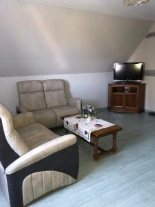 a living room with a couch and a coffee table at Gite chez Annette et Pierre Weber in Niedernai