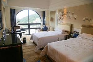 Ένα ή περισσότερα κρεβάτια σε δωμάτιο στο Shenzhen Dayhello international Hotel (Baoan)