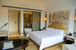 Ένα ή περισσότερα κρεβάτια σε δωμάτιο στο Shenzhen Dayhello international Hotel (Baoan)