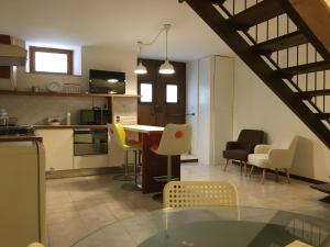 a kitchen and living room with a table and chairs at Slow Umbria 05039 in Stroncone
