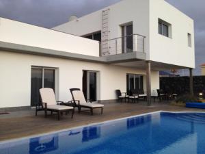 a villa with a swimming pool and a house at Petit Paradis - A little bit of heaven in Callao Salvaje