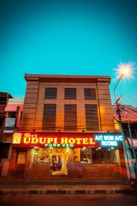 a building with a sign on the side of it at Sri Udupi Hotel in Trivandrum