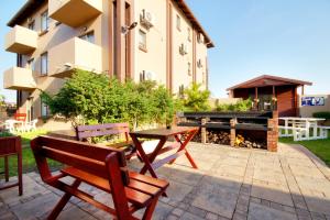 two benches and a table in front of a building at Seagull Lodge in Richards Bay