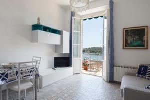 a living room with a table and a television at Punti di Vista in Portovenere +14 photos