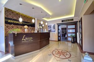 a lobby of a hotel with a reception desk at Lazur Wellness@Spa in Międzywodzie