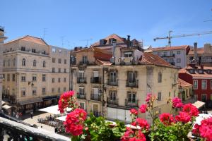 a view of a city from a balcony with flowers at Lx Flowers Apartments in Lisbon