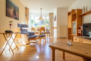 a living room with a table and chairs at Kurmittelcentrum Zingst in Zingst