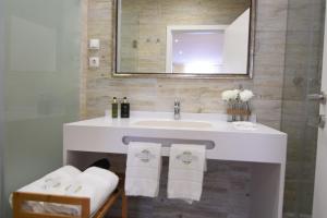 a bathroom with a sink, mirror and bath tub at Lx Flowers Apartments in Lisbon