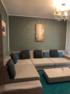 a living room with a couch and a table at Grand Eforie Apartment in Eforie Nord